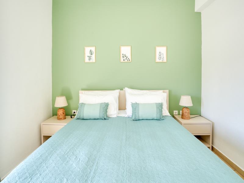 Double bed with botanical prints and bedside lamps