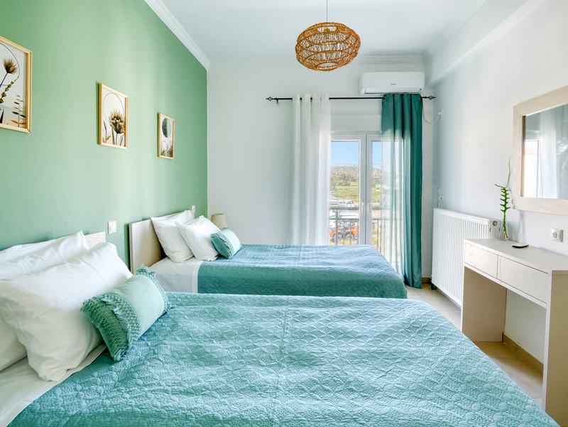 Twin bedroom with dressing table and window